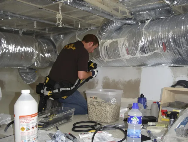 Central Falls Air Duct Cleaning specialist performing professional mold removal from air ducts in Central Falls