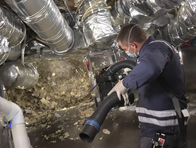 Central Falls Air Duct Cleaning specialist operating negative pressure cleaning equipment for thorough duct maintenance in Central Falls
