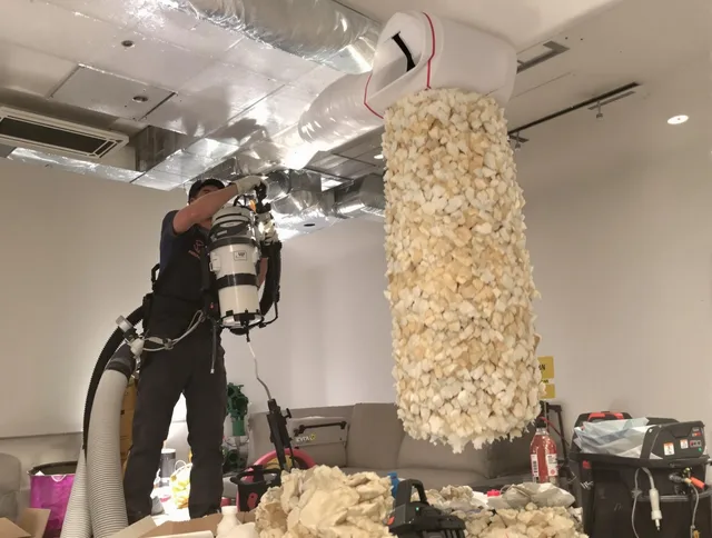 Central Falls Air Duct Cleaning technician performing precision vacuum insulation removal in a residential property in Central Falls