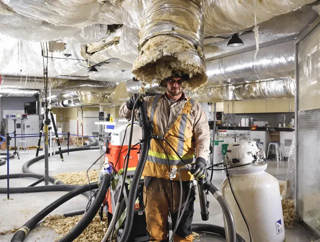 Professional vacuum insulation removal by Central Falls Air Duct Cleaning expert in Central Falls